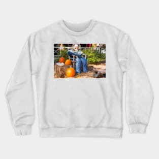 Halloween Mannequin in with ugly mask chair outside beside three large orange pumpkins Crewneck Sweatshirt